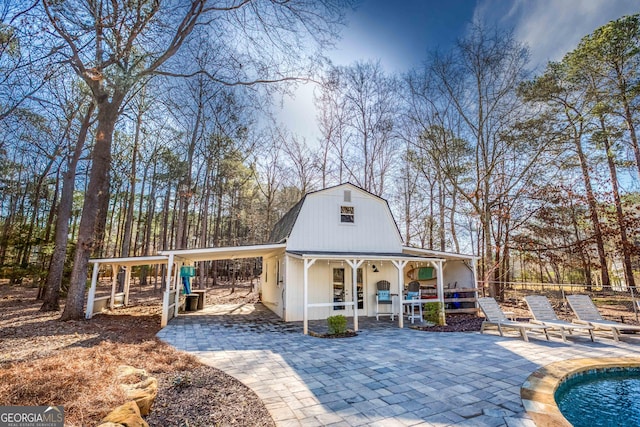 view of outdoor structure featuring an outdoor pool and fence