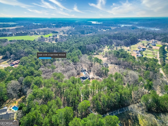 aerial view featuring a wooded view