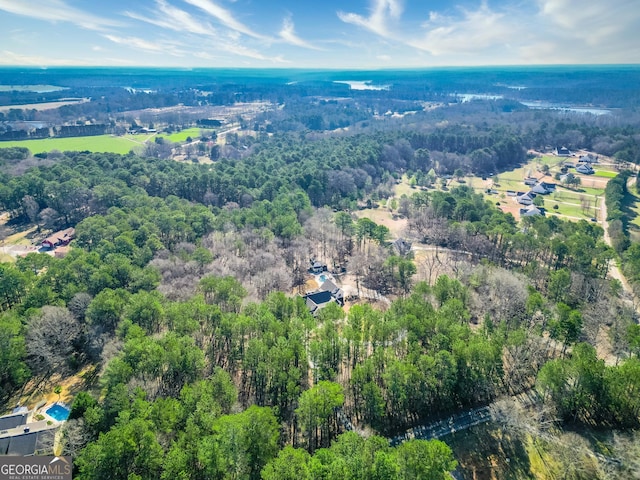 birds eye view of property with a forest view