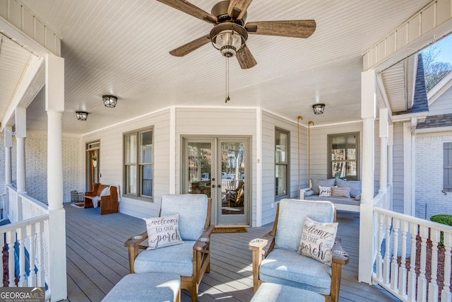 deck with a porch and ceiling fan