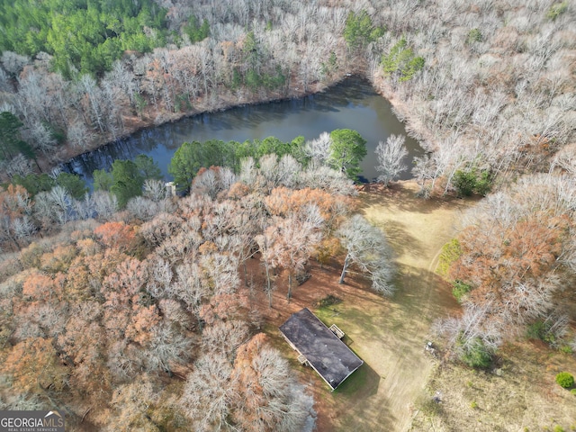 birds eye view of property with a wooded view and a water view