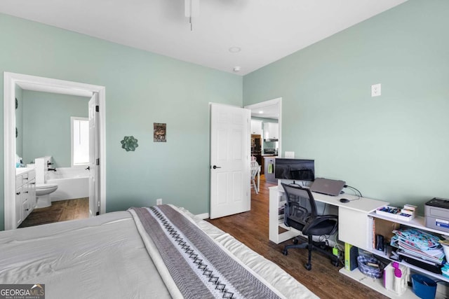 bedroom with ensuite bath and wood finished floors