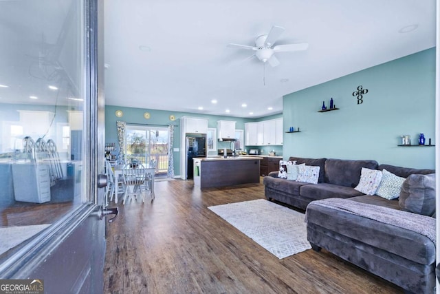 living room with a ceiling fan, recessed lighting, and dark wood-style flooring