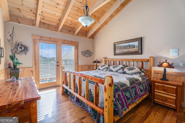 bedroom with vaulted ceiling with beams, wooden ceiling, wainscoting, and access to exterior