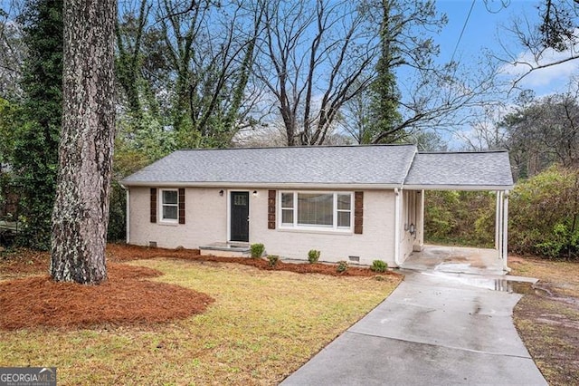 ranch-style home with an attached carport, a front yard, concrete driveway, crawl space, and brick siding