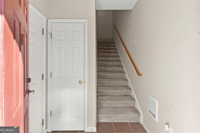 stairs featuring visible vents and baseboards