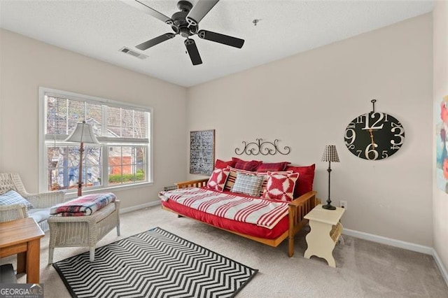 bedroom featuring visible vents, baseboards, carpet, and ceiling fan