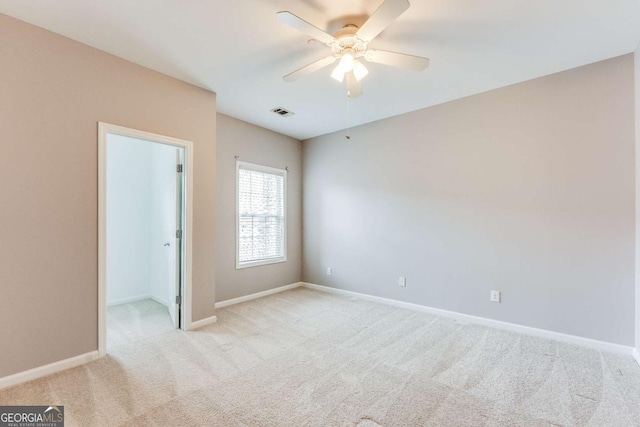 unfurnished bedroom with a spacious closet, visible vents, ceiling fan, baseboards, and carpet floors