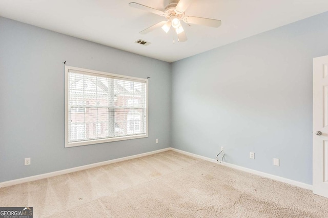 spare room featuring visible vents, baseboards, carpet, and a ceiling fan