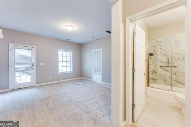 interior space with visible vents, carpet floors, and baseboards