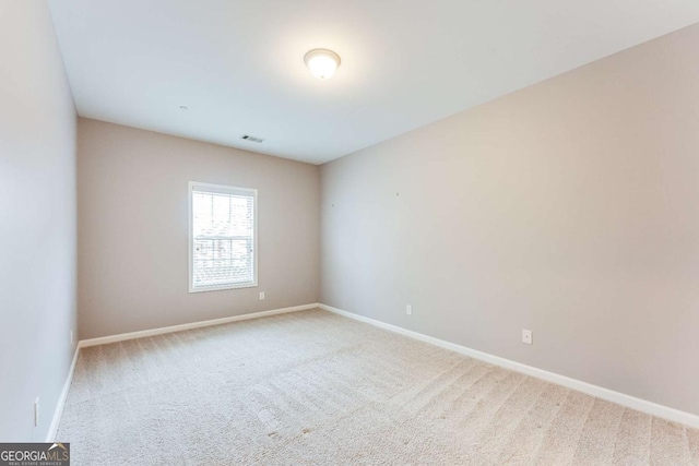 unfurnished room with baseboards, visible vents, and carpet floors