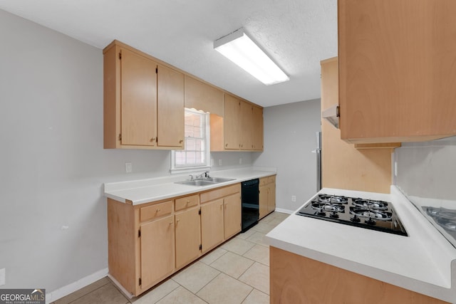 kitchen featuring black appliances, light tile patterned floors, light countertops, and a sink