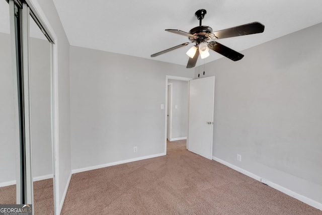 unfurnished bedroom with carpet flooring, baseboards, and a closet