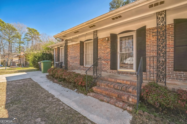 view of front of house with brick siding and covered porch