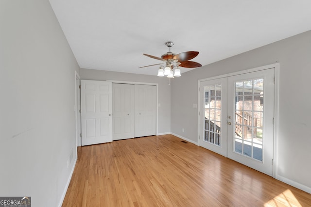 unfurnished bedroom featuring access to exterior, light wood finished floors, french doors, and baseboards