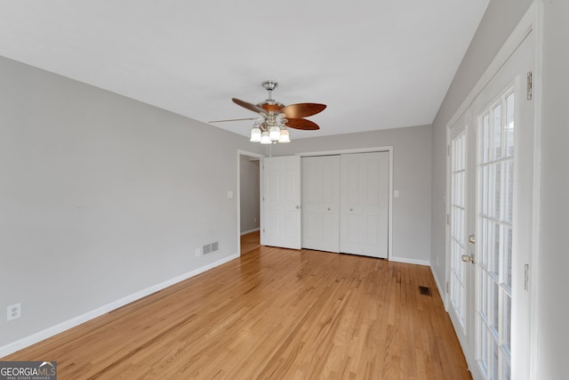 unfurnished bedroom with visible vents, baseboards, a closet, and light wood-style flooring