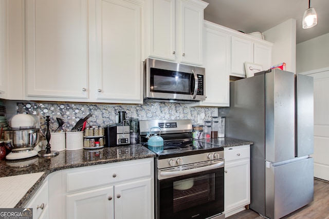 516 Grand Magnolia St, Jackson, GA 30233 - kitchen with stainless steel appliances, white cabinetry, decorative backsplash, wood finished floors, and dark stone countertops