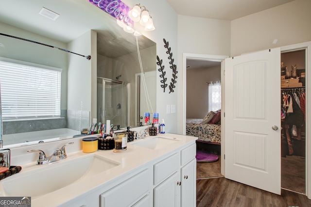516 Grand Magnolia St, Jackson, GA 30233 - ensuite bathroom with a shower stall, wood finished floors, a garden tub, double vanity, and a walk in closet