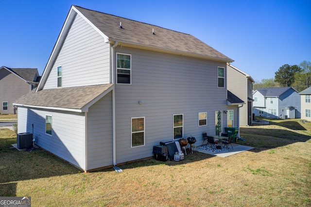 516 Grand Magnolia St, Jackson, GA 30233 - back of house featuring a patio, a yard, central AC, and roof with shingles
