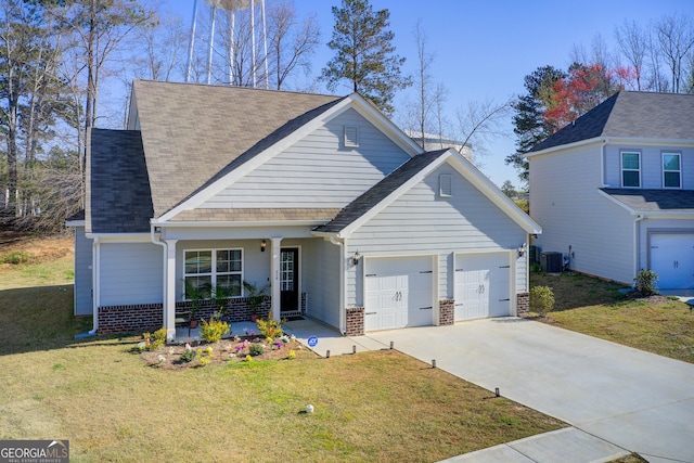 516 Grand Magnolia St, Jackson, GA 30233 - traditional home with covered porch, cooling unit, a garage, a front yard, and concrete driveway