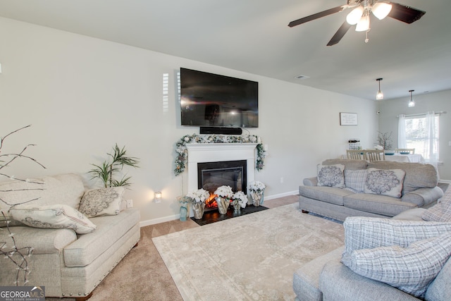 516 Grand Magnolia St, Jackson, GA 30233 - carpeted living room featuring a ceiling fan, a fireplace with flush hearth, and baseboards