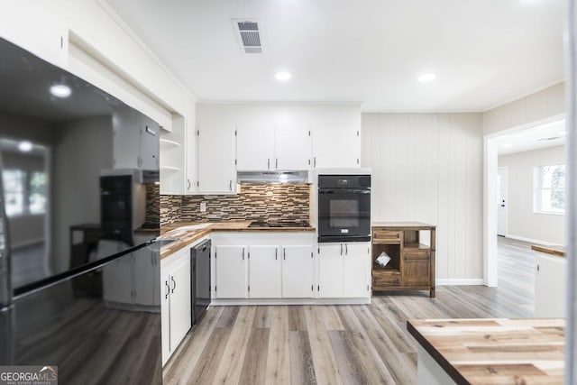 kitchen featuring black appliances, white cabinets, visible vents, and under cabinet range hood