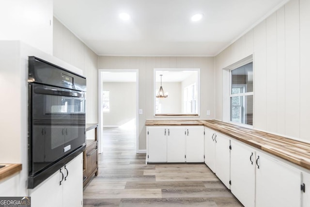 kitchen featuring a chandelier, recessed lighting, light wood-style flooring, white cabinets, and wood counters