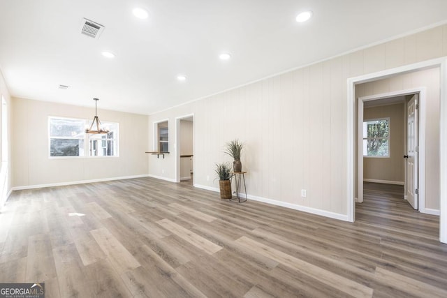 unfurnished living room featuring visible vents, recessed lighting, baseboards, and wood finished floors