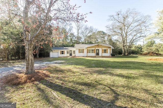 ranch-style home featuring an attached garage, driveway, and a front lawn