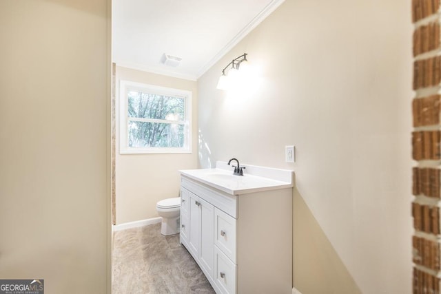 bathroom featuring visible vents, toilet, ornamental molding, baseboards, and vanity