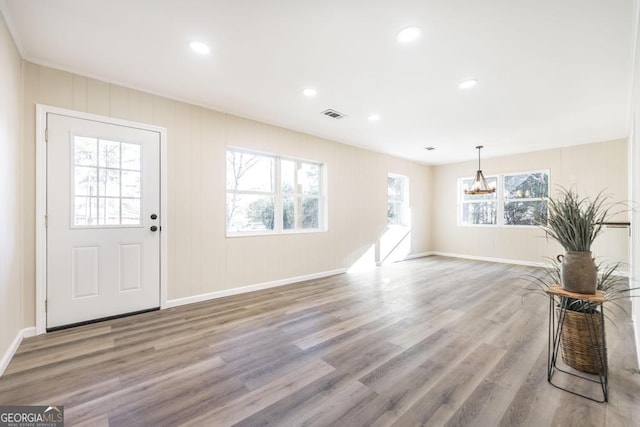 foyer featuring recessed lighting, wood finished floors, and visible vents