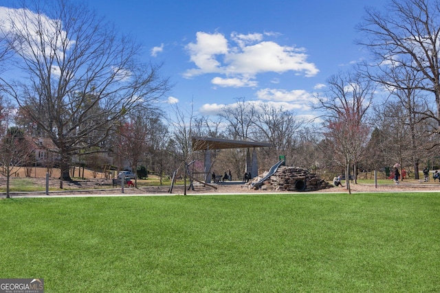 community jungle gym featuring a lawn