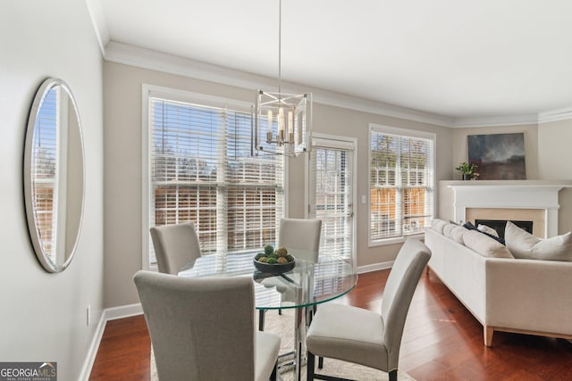 dining area featuring dark wood-style floors, baseboards, and ornamental molding