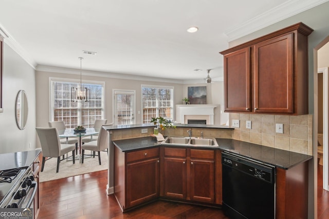 kitchen with a sink, black dishwasher, dark countertops, a peninsula, and stainless steel range with gas stovetop