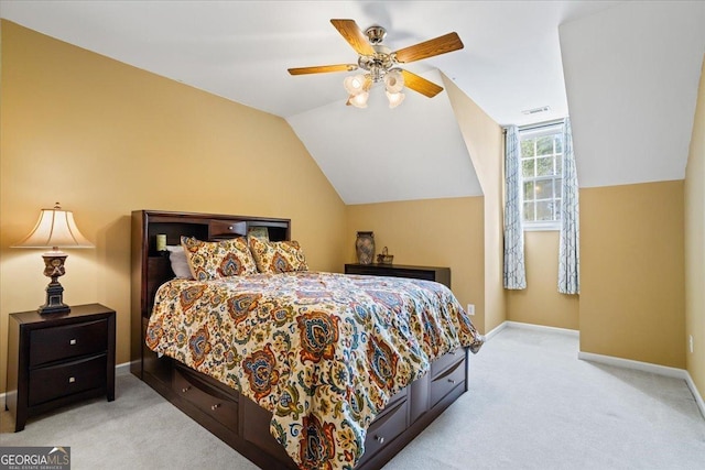 carpeted bedroom with lofted ceiling, visible vents, baseboards, and ceiling fan