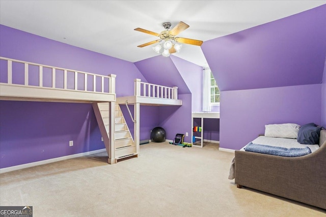 carpeted bedroom with baseboards, lofted ceiling, and a ceiling fan