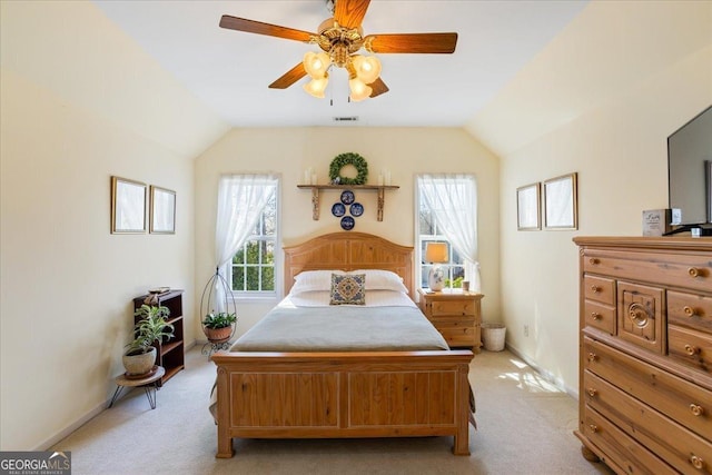 bedroom with vaulted ceiling, baseboards, visible vents, and light carpet