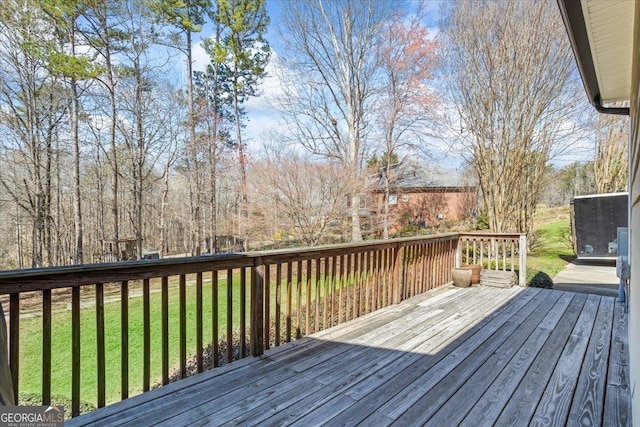 wooden deck featuring a yard