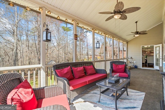 sunroom / solarium featuring vaulted ceiling, wooden ceiling, and ceiling fan