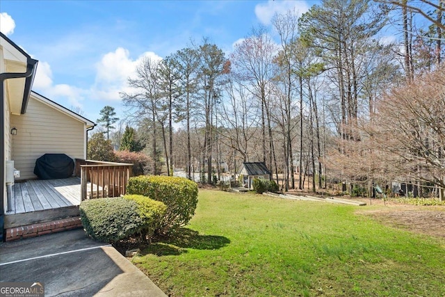 view of yard featuring a wooden deck