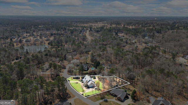 bird's eye view with a view of trees and a water view