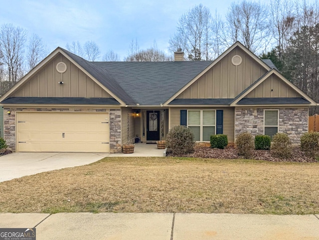 craftsman-style house with a front yard, a chimney, a garage, stone siding, and driveway