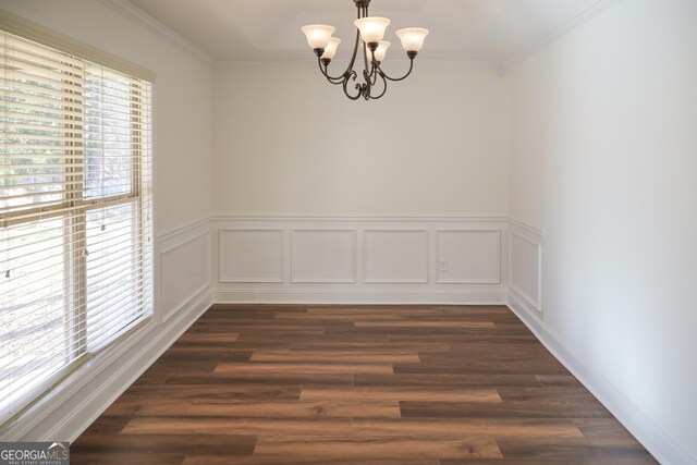 unfurnished dining area featuring a notable chandelier, a healthy amount of sunlight, and crown molding