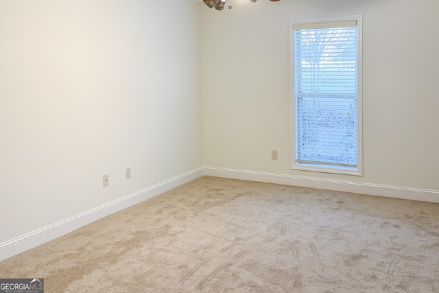 carpeted empty room with baseboards