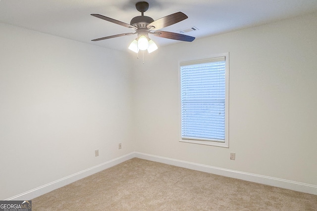 unfurnished room with a ceiling fan, baseboards, visible vents, and light carpet