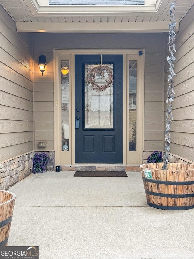 view of exterior entry with covered porch