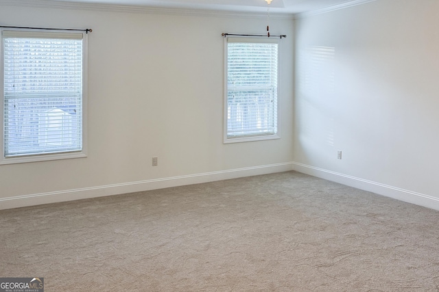 carpeted spare room with baseboards and ornamental molding