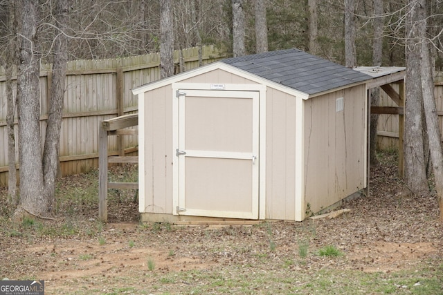 view of shed with fence