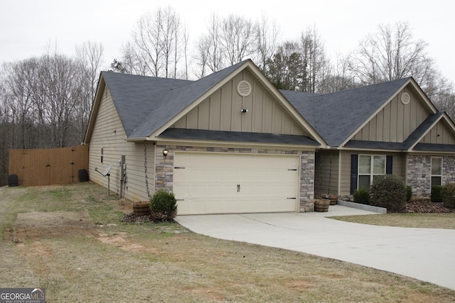 craftsman house with a gate, stone siding, board and batten siding, concrete driveway, and an attached garage