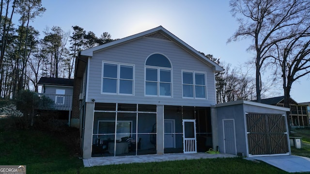 1550 Shady Oaks Ln, Greensboro, GA 30642 - rear view of house featuring a yard, an outbuilding, a sunroom, and a storage unit